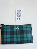 Front view of plaid Coach wristlet with MaxSold tag