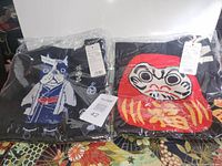 Both knit tote bags in packaging showing designs