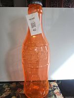 Full view of orange Coca-Cola coin bank