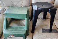 Green two-step stool and black round stool side by side