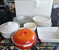 group shot showing all items: ceramic pots, glass bowls, plastic bowl, plates, tray