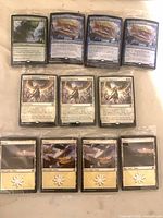 Front view of eleven individually sealed foil Magic cards in three groups: Charix, Sigarda's Summons, Plains