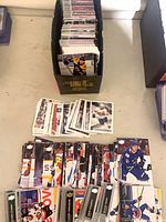 Box and spread of Upper Deck hockey base cards showing quantity and variety.
