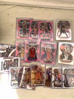 Spread of sleeved Panini Prizm cards showing pink parallels and base cards; visible players Damian Lillard, Nikola Vucevic etc.