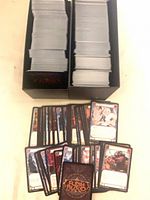 Two black trays filled with stacked Flesh and Blood cards