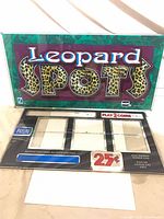 Topper backglass and lower reel window glass displayed together