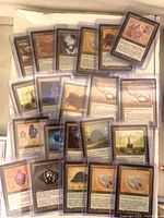Group of sleeved retro-frame artifact cards spread out