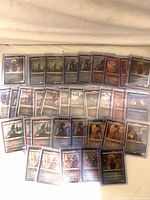 Full lot of 65 sleeved foil-etched Legendary Creature cards spread out
