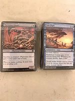 Two wrapped stacks, top cards Phyrexian Ghoul and Take Flight visible