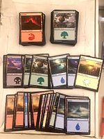 Stacks of different basic lands visible: Mountains, Forests