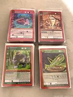 Four stacks of sleeved MetaZoo reverse holo cards showing variety of top cards