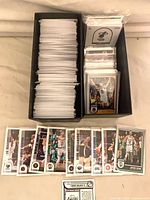 Long card box filled with rows of sleeved 2022-23 Panini Hoops cards and several top-loaded cards at front