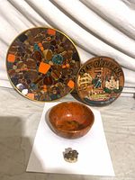 Group shot of all four items: mosaic plate, New Orleans plaque, bowl, figurine