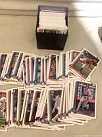 Spread of Topps baseball cards and storage box