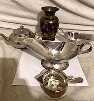 Group shot of teapot, gravy boat, creamer and vase