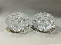Pair of Orrefors Raspberry crystal candle holders front view