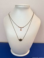 Both sterling silver necklaces displayed on bust