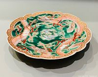 top view of scalloped porcelain plate with dragon design