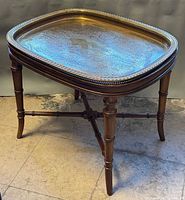 Overall view of side table showing brass tray top and wood base