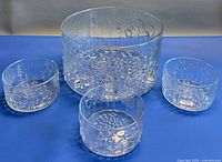 Overview of large Flora serving bowl with three small bowls