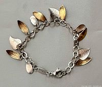 Full view of bracelet showing leaf charms and chain