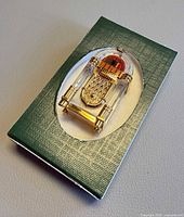 Crystal jukebox inside green inner box with cut-out window