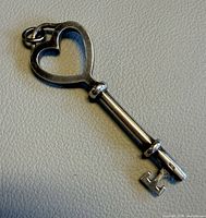 Sterling silver heart key pendant front view showing 925 mark