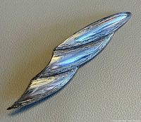 Front view of abstract silver-tone brooch