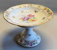 Compote side angle displaying floral bowl, pedestal base, gold rim