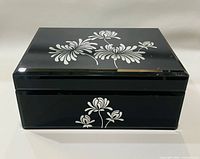 Closed box front view showing floral motif