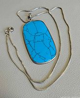 Full view of sterling snake chain and turquoise-style pendant