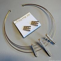 Set laid out showing necklace shape and earrings on card