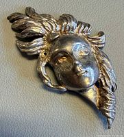 Front view of sterling figural head brooch