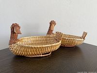 Two duck-shaped wicker baskets side view