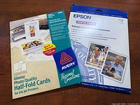 Front view of two sealed packages: Epson photo paper and Avery glossy half-fold cards