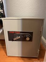 Front view of Fire Fyter safe showing combination dial, handle and logo