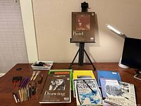 Overall view of easel, pads, tools on desk