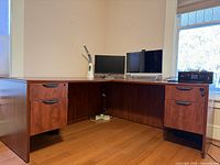 Front view showing L-shape, cherry finish, double pedestals