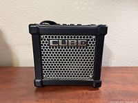 Front view showing CUBE badge and grille