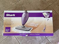 Front of Shark Steam Mop retail box showing product picture and features