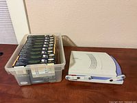 Printer and plastic bin containing photo paper packs