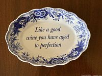 Top view of oval Spode trinket dish displaying floral border and inscription