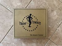 Closed cardboard box showing Trim-Twist branding and logo