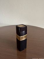 Front view of black and gold Chanel N°5 spray cologne bottle