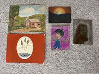 All five paintings laid out on carpet