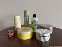 Group shot of all seven vintage bath and vanity containers