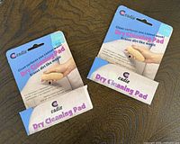 Front view of two sealed Cadie dry cleaning pad packages
