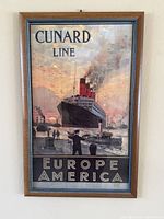 Full view of framed Cunard Line advertising print on wall
