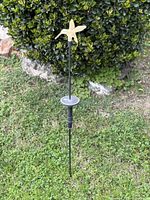 Full view of hummingbird solar stake in lawn