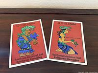 Both postcards side by side on wooden surface